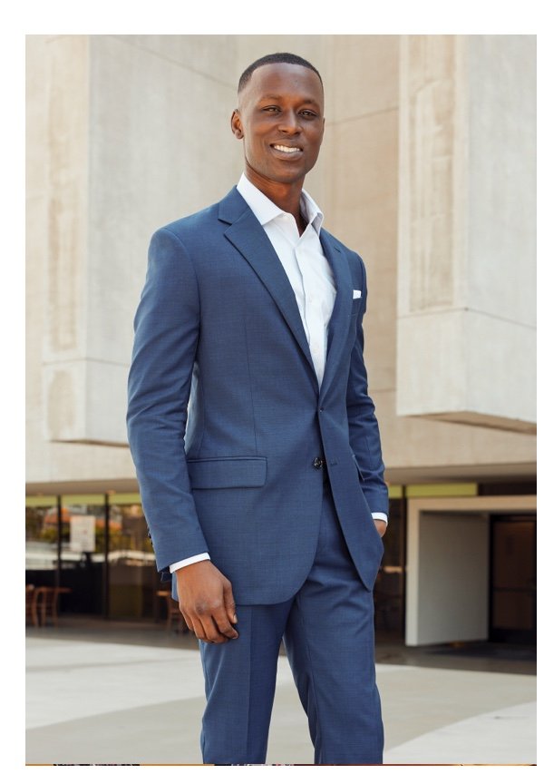 Man in blue suit smiling for the camera